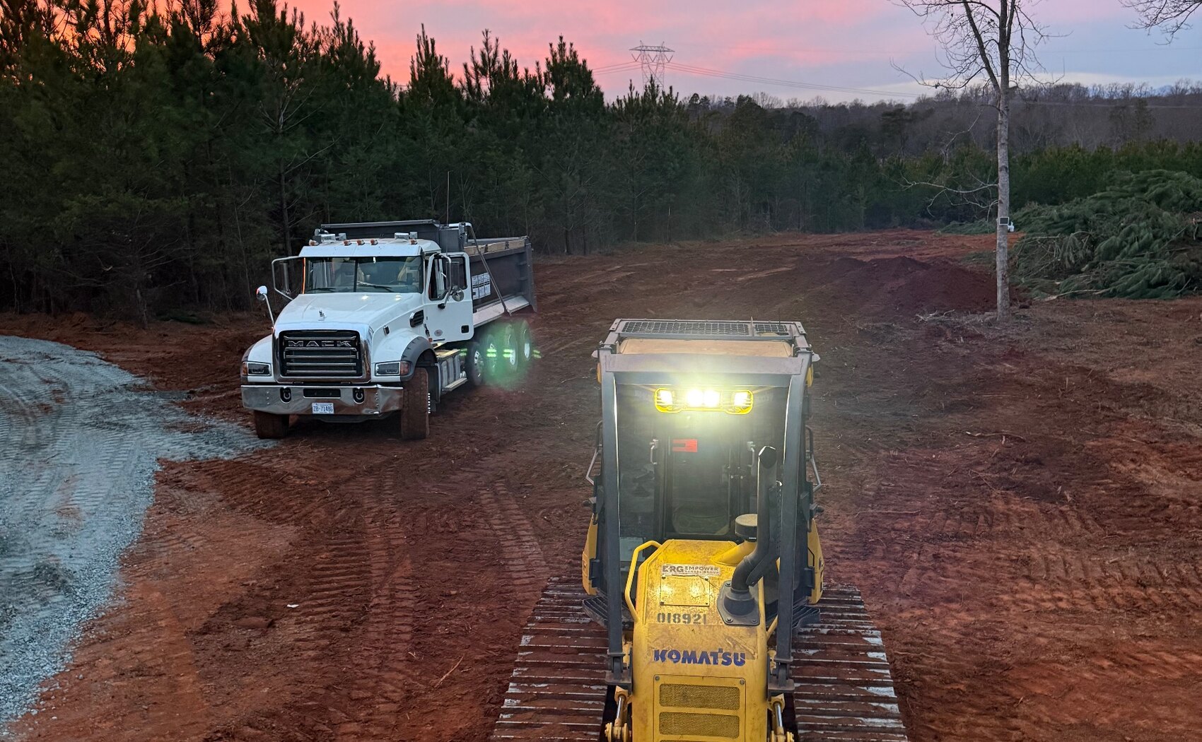 BB's Land Management dozer and truck on a fresh grade at golden hour in Western North Carolina